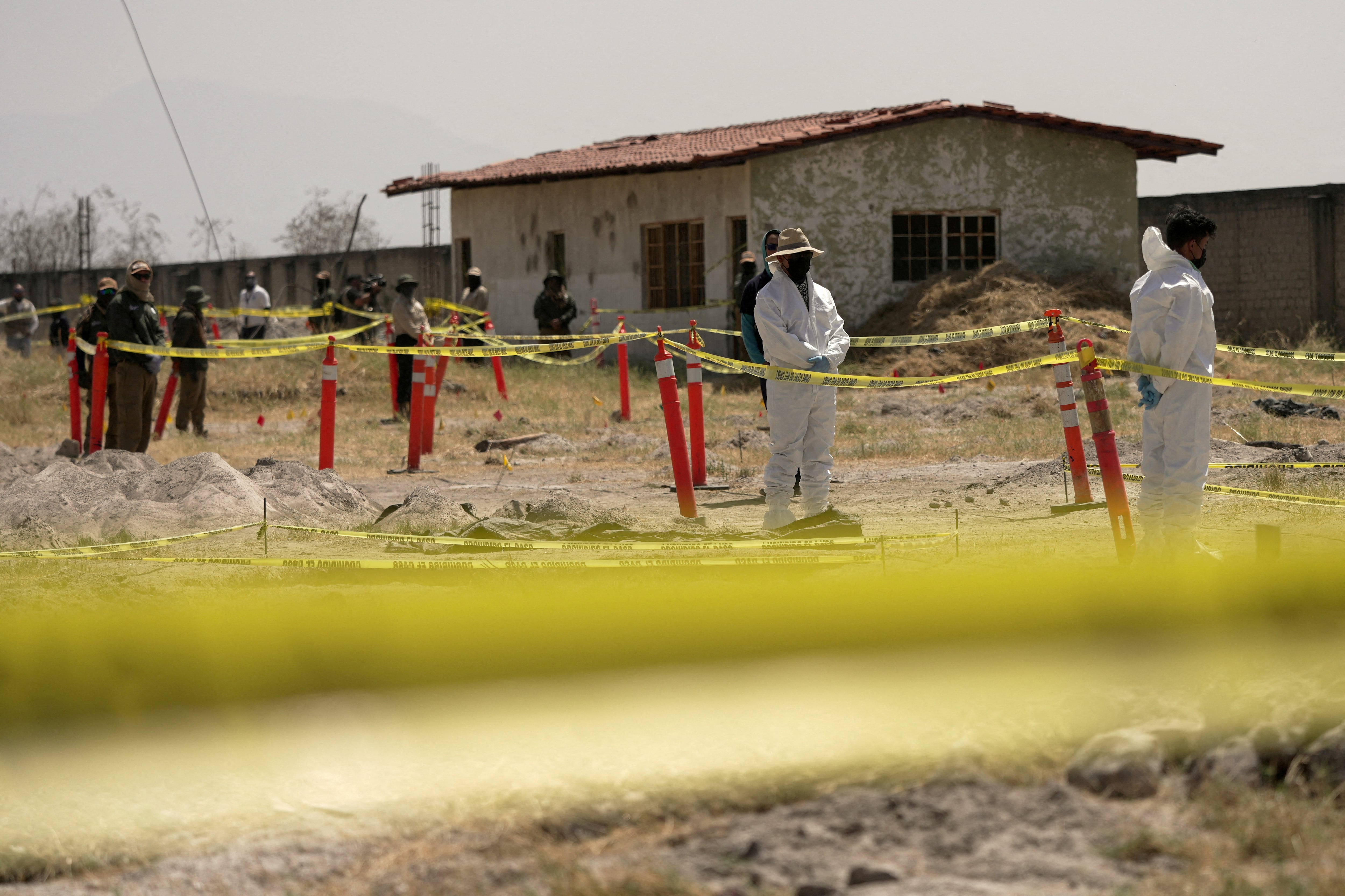 FILE PHOTO: Forensic technicians stand at a cordoned area during a media tour by Jalisco