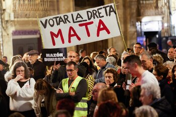People hold a sign that