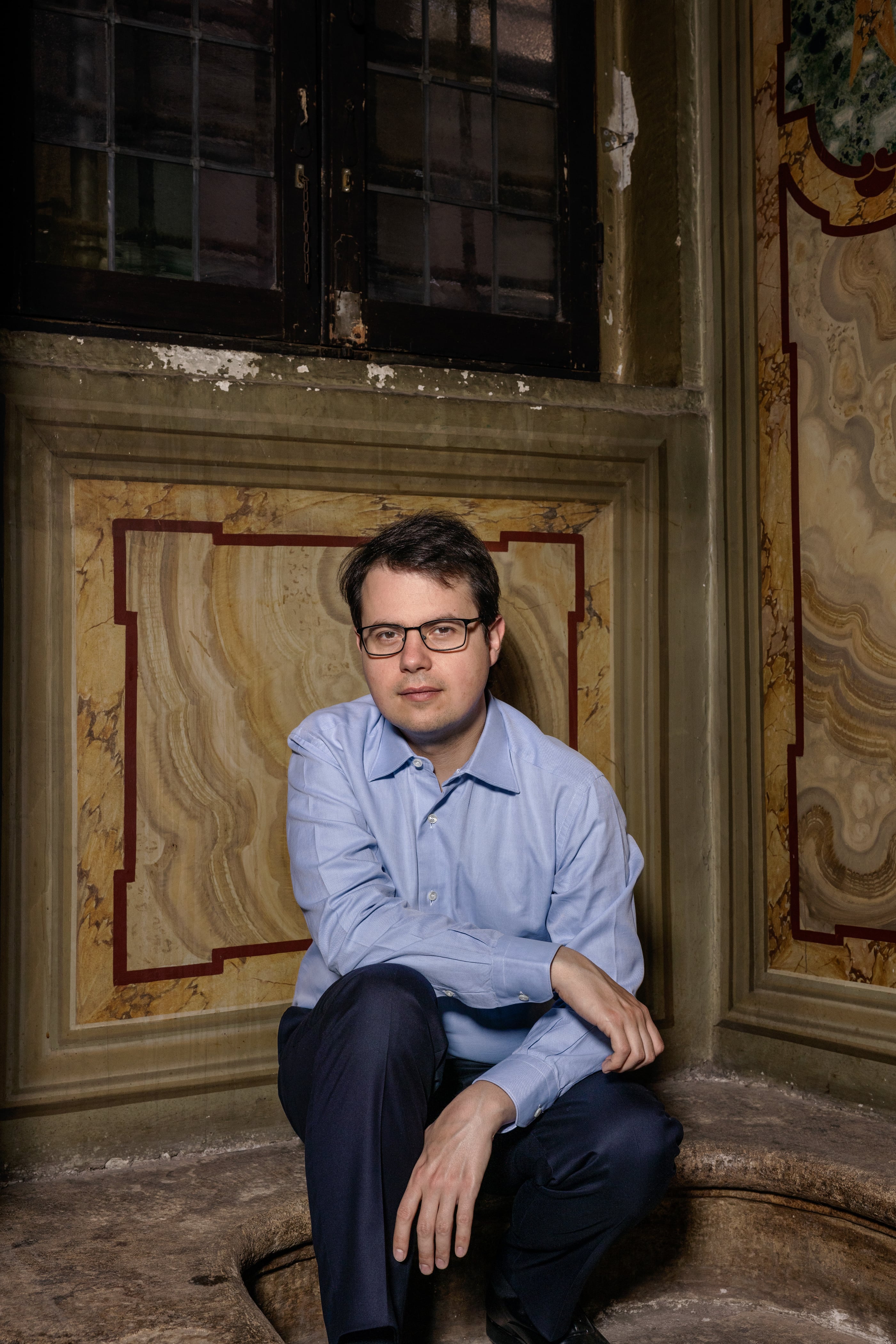 Christopher Olah, one of Anthropic’s co-founders, who leads the team responsible for understanding why artificial intelligence systems like the company’s Claude act the way they do, at the Lancisiana Library in Rome, May 26, 2026. In private meetings, Anthropic consulted religious scholars to help instill morality into its AI models — and make the case that Claude could be conscious. (Alessandro Penso/The New York Times)