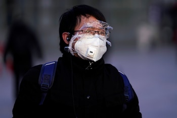 A passenger wearing a mask walks at the Shanghai railway station in China, as the country is hit by an outbreak of the novel coronavirus, February 9, 2020. REUTERS/Aly Song