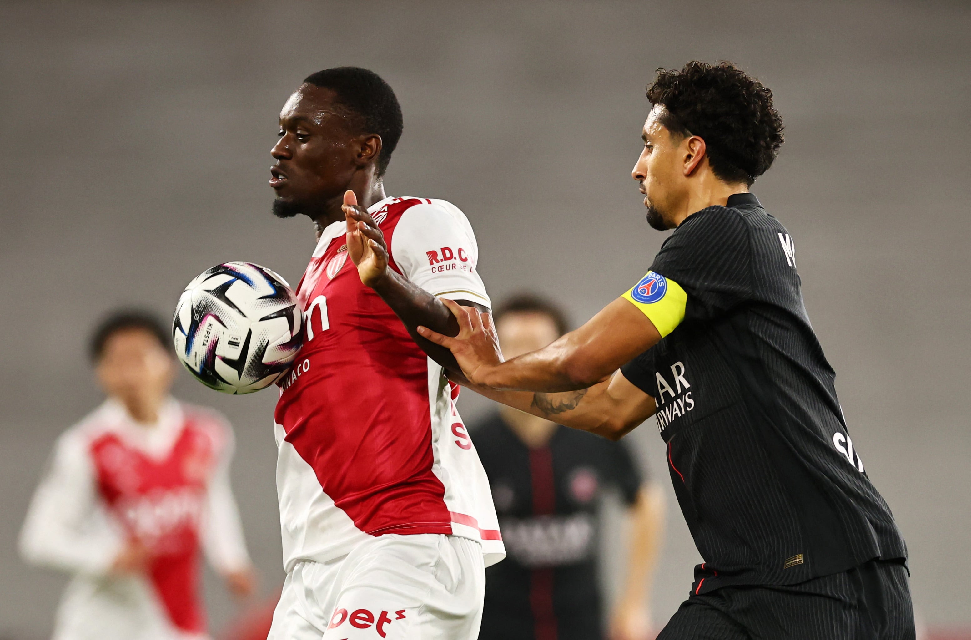 Soccer Football - Ligue 1 - AS Monaco v Paris St Germain - Stade Louis II, Monaco - November 29, 2025 AS Monaco's Folarin Balogun in action with Paris St Germain's Marquinhos REUTERS/Manon Cruz