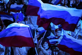 Youth from the Young Army movement (Yunarmiya) cheer ahead of a welcoming ceremony for the athletes of the Russian Olympic Committee returning from the Beijing 2022 Winter Olympic Games in Moscow, Russia February 21, 2022. REUTERS/Maxim Shemetov