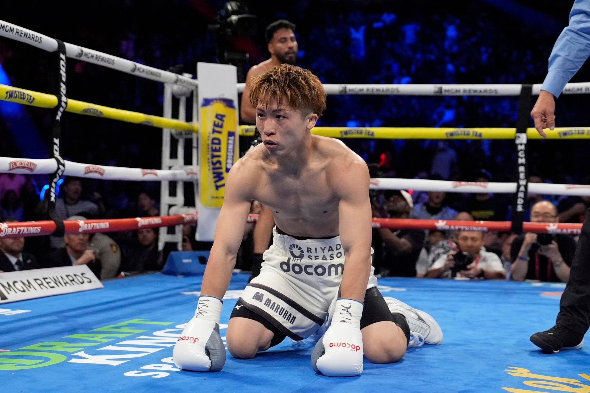 Naoya Inoue kneels on the mat after he was knocked down by Ramon Cardenas in a junior featherweight title boxing match Sunday, May 4, 2025, in Las Vegas. (AP Photo/John Locher)