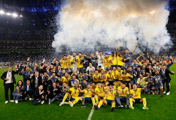 Soccer Football - Liga MX - Final - Second Leg - Monterrey v America - Estadio BBVA, Monterrey, Mexico - December 15, 2024 America players and staff pose for a picture with the trophy after winning the championship of Liga MX for the third time, first since 1985 REUTERS/Daniel Becerril