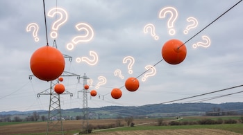 Bolas naranjas y signos de interrogación luminosos flotan alrededor de cables de alta tensión y torres eléctricas sobre campos y colinas bajo un cielo nublado.