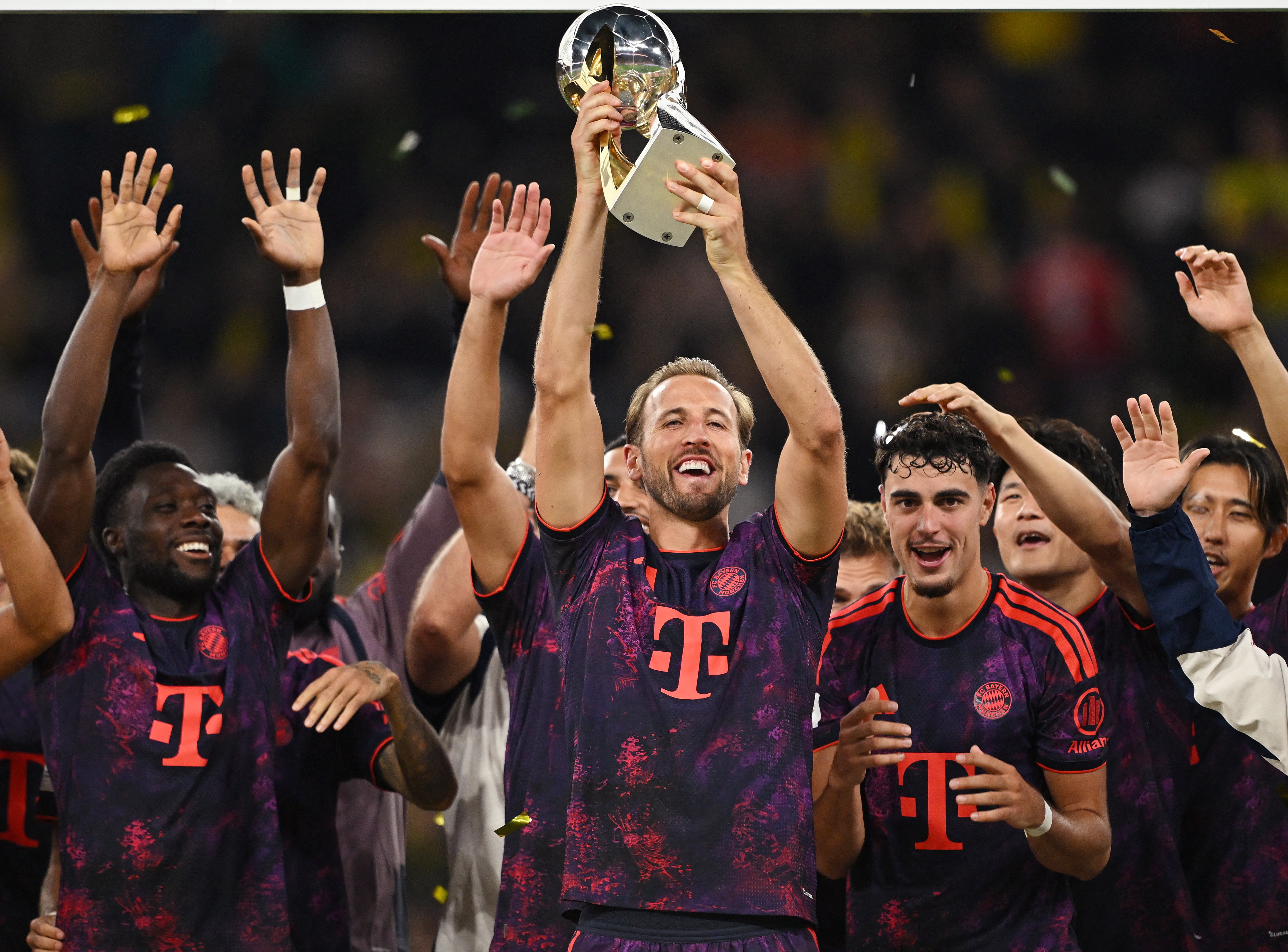 Harry Kane, del Bayern Múnich, levanta el trofeo junto a Alphonso Davies y Aleksandar Pavlovic tras ganar la final de la Supercopa DFL-crédito Teresa Kroeger/REUTERS