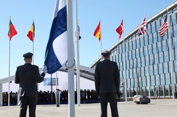 Military personnel prepare to raise the flag of Finland during a flag raising ceremony on the sidelines of a NATO foreign ministers meeting at NATO headquarters in Brussels, Tuesday, April 4, 2023. Finland joined the NATO military alliance on Tuesday, dealing a major blow to Russia with a historic realignment of the continent triggered by Moscow's invasion of Ukraine. (AP Photo/Geert Vanden Wijngaert)