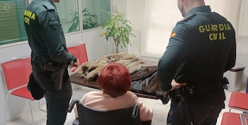 La mujer afectada y los agentes frente a los abrigos de piel (Guardia Civil)