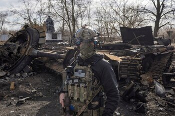 A Ukrainian serviceman walks past