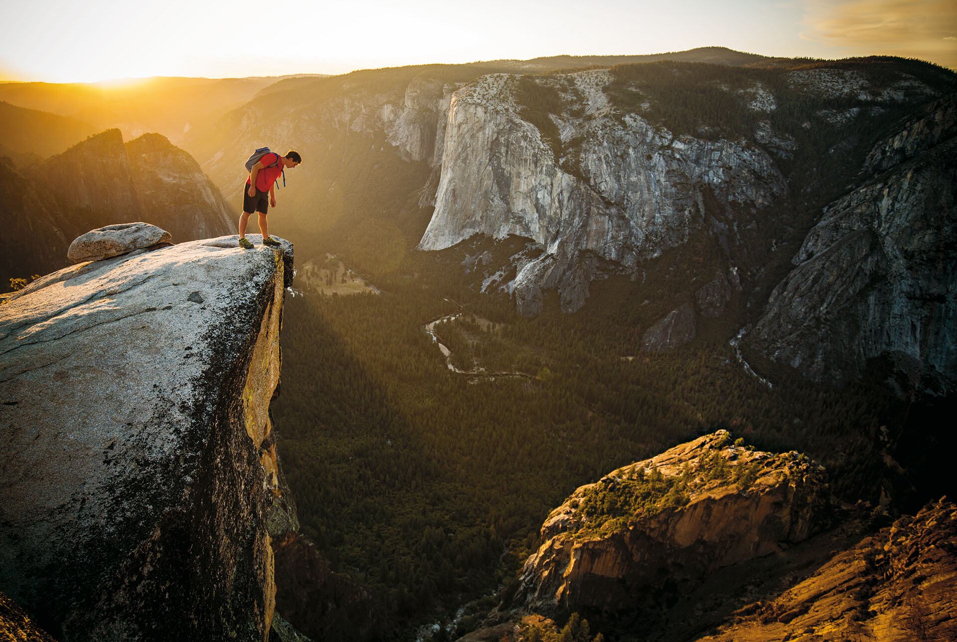 Honnold peers over the edge of Taft Point, across the Yosemite Valley from the granite escarpment known as El Capitan. Each year Honnold devotes several months to climbing the park’s iconic walls and boulders. “Yosemite,” he says,“is my favorite place in the whole world.” (Jimmy Chin)