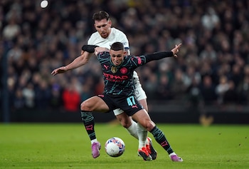 26 January 2024, United Kingdom, London: Manchester City's Phil Foden holds off Tottenham Hotspur's Pierre-Emile Hojbjerg during the Emirates FA Cup fourth round soccer match between Tottenham Hotspur and Manchester City at the Tottenham Hotspur Stadium, London. Photo: Bradley Collyer/PA Wire/dpa