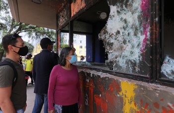 People look at a vandalised