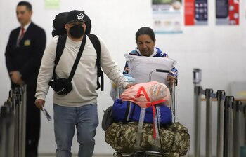 Venezuelan migrants walk to board