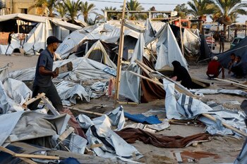 Palestinos inspeccionan el campamento de tiendas de campaña que albergaba a personas desplazadas después del ataque israelí en el sur de la Franja de Gaza (REUTERS/Mohammed Salem)