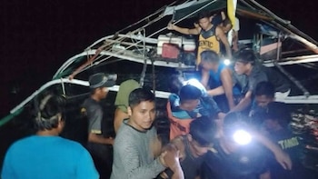 En esta imagen proporcionada por la Guardia Costera de Filipinas, personas desembarcan de un pequeño bote tras ser rescatados de un transbordador en llamas frente a la costa de la provincia de Palawan, Filipinas, el miércoles 9 de septiembre de 2026 (Guardia Costera de Filipinas vía AP)