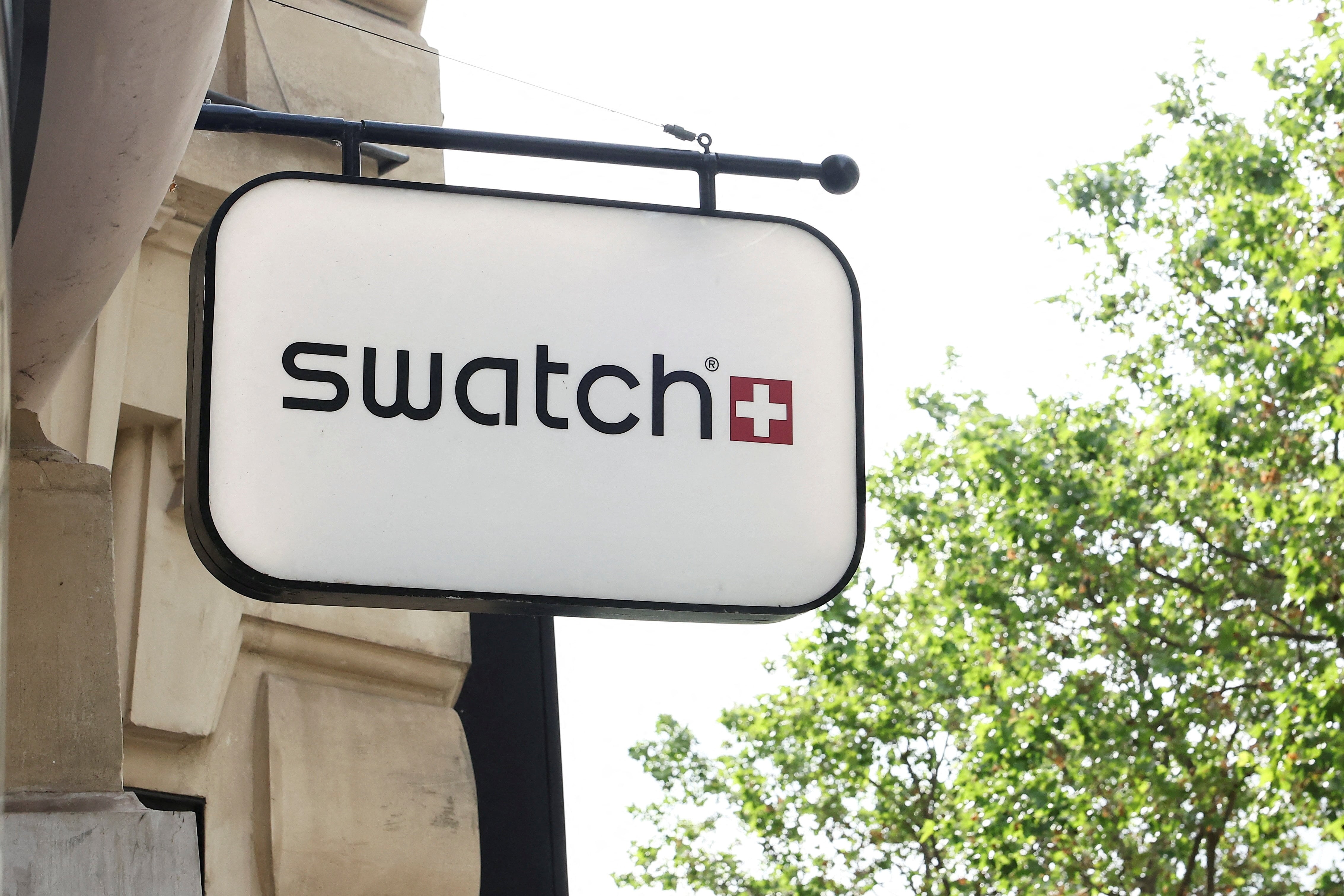 FILE PHOTO: The logo of Swiss watch manufacturer Swatch is displayed outside a store, as the new limited-edition 'Royal Pop', a collaboration between Swatch and luxury brand Audemars Piguet, is out of stock in Paris, France, May 18, 2026. REUTERS/Alice Sacco/File Photo