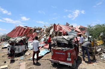 Somalis inspect the damage caused at the scene of an attack on an Italian military convoy in Mogadishu, Somalia September 30, 2019. REUTERS/Feisal Omar