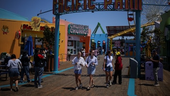 Visitors walk along the Santa Monica Pier in Santa Monica