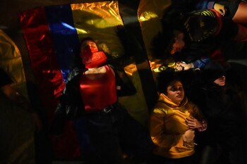 Demonstrators perform as victims of