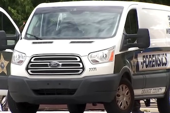Un furgón blanco Ford Transit con el logo del condado de Orange y la palabra "FORENSICS" en el lateral, con el número 7771 en el frente