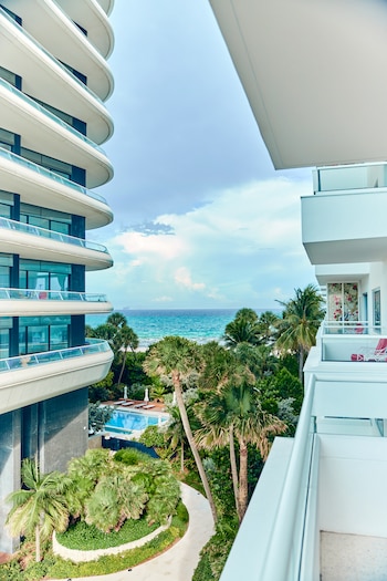The view, offering a sliver of beach, from the balcony of the writer Mya GuarnieriÕs room at the Faena Miami Beach hotel in Miami Beach, Fla., on Aug. 14, 2026. Women of a certain age and marital status are embracing a social media trend of indulgence, big hats, long dresses and, maybe, empowerment. (Mary Beth Koeth/The New York Times)