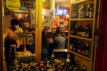 People sit inside a bar