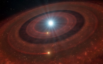 This illustration shows a debris disc around the white dwarf J1328−1450 –– the dead core of a star similar to our Sun that expelled its outer layers at the end of its lifetime. The star was suspected to have a planetary system that was vaporised to rubble as the star died, and this debris ended up arranged in a disc like the one shown here. The disc contains both gas and dust, but the gas appears to be arranged in a unique way. Using the X-shooter instrument on ESO’s Very Large Telescope (VLT) astronomers measured the speed of the gas orbiting the white dwarf, and found that it moves at two distinct speeds. This indicates that the gas is distributed in two concentric discs with a gap in between. The most likely explanation is that these two gaseous discs are maintained by two planetesimals that survived the death of the star. As they orbit the white dwarf they interact with dust grains in the disc, releasing gas in the process, shown here as luminous trails.