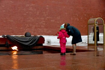 Relatives of Russian soldiers, taking part in the so-called "special military operation" in Ukraine, lay flowers at the Tomb of the Unknown Soldier in Moscow on December 23, 2023. (Photo by Olga MALTSEVA / AFP)