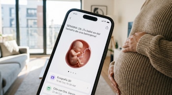 Primer plano de un celular con una app de embarazo mostrando la "Semana 28", una ilustración de feto, recordatorios, y una mujer embarazada tocando su vientre.