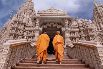 Monks walk at the BAPS Hindu Mandir temple, in Abu Dhabi, United Arab Emirates, February 7, 2024. REUTERS/Amr Alfiky