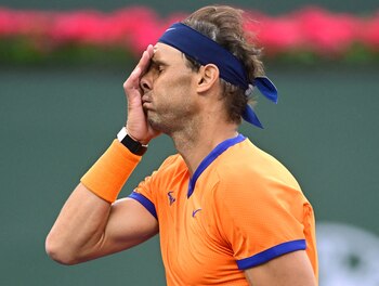FILE PHOTO: Mar 19, 2022; Indian Wells, CA, USA; Rafael Nadal (ESP) reacts after missing a shot during a victory over Carlos Alcaraz (ESP) in their semifinal match in the BNP Paribas Open at the Indian Wells Tennis Garden. Mandatory Credit: Jayne Kamin-Oncea-USA TODAY Sports/File Photo