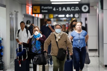 Pasajeros en el aeropuerto internacional de El Salvador, uno de los países de la región que por ahora no tuvo casos positivos de coronavirus
