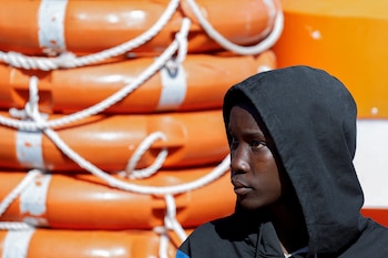 A migrant waits to disembark