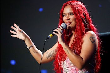 Karol G gestures as she