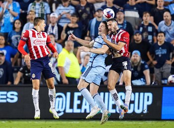 Jul 31, 2023; Kansas City, KS, USA; Sporting Kansas City defender Andreu Fontas (3) and Chivas Guadalajara defender Antonio Briseno (4) go up for a header as Chivas forward Ronaldo Cisneros (18) looks on during the second half at Children's Mercy Park. Mandatory Credit: Jay Biggerstaff-USA TODAY Sports