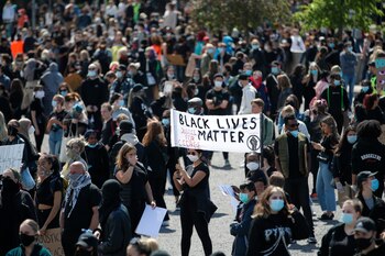 Protesters hold placards as they attend a demonstration organised to show solidarity with the Black Lives Matter movement, in Gothenburg, Sweden, Sunday, June 7, 2020. in response to the recent killing of George Floyd by police officers in Minneapolis, USA, that has led to protests in many countries and across the US. (Adam Ihse/TT News Agency via AP)