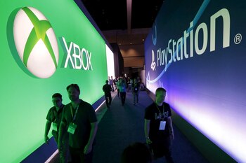 FILE PHOTO: Attendees walk past a Microsoft Xbox sign opposite a Sony PlayStation sign at the Electronic Entertainment Expo, or E3, in Los Angeles, California, United States, June 16, 2015. REUTERS/Lucy Nicholson/File Photo