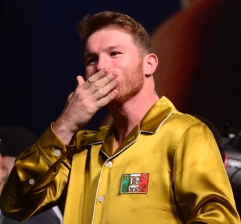 Nov 5, 2021; Las Vegas, Nevada, USA; Canelo Alvarez blows a kiss to his family after weighing in for his super middleweight championship boxing match against Caleb Plant (not pictured) at MGM Grand Garden Arena. Mandatory Credit: Joe Camporeale-USA TODAY Sports
