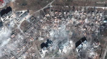 This satellite image provided by Maxar Technologies shows damaged apartment buildings and homes in Mariupol, Ukraine, Tuesday, March 29, 2022. (Maxar Technologies via AP)
