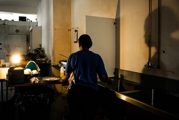 Workers in a cafe use