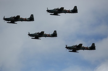 Embraer A-29 Super Tucano aircrafts fly in formation as they arrive in Luque, Paraguay June 30, 2025. REUTERS/Cesar Olmedo