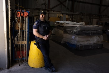 Canadian Border Services Officer Frédéric Bonsaint after searching a shipping container suspected of transporting stolen vehicles, in Montreal, Quebec, Canada, June 8, 2026. A yearslong car theft epidemic in Canada has gotten so bad that, despite a police crackdown, thieves break into homes just to steal car keys. Thousands of cars vanish each year. (Nasuna Stuart-Ulin/The New York Times)
