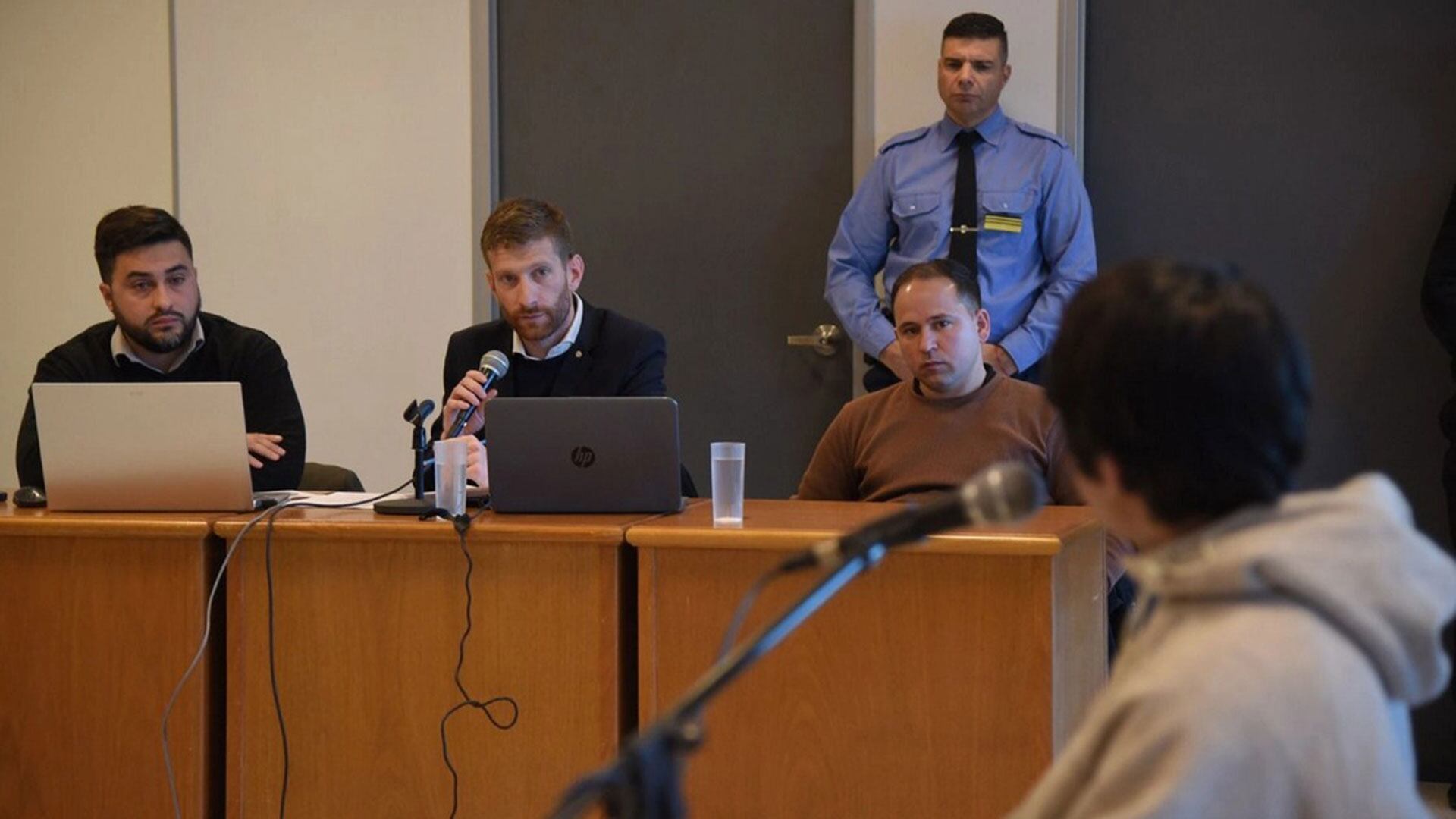 Sentado, a la derecha de la imagen y debajo de un policía, el oficial inspector Galván durante el juicio en su contra (Foto: La Arena)