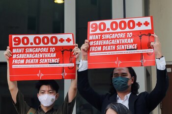 Activistas sostiene pancartas en contra