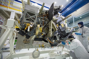 In an undated image provided by Chris Gunn/NASA, engineers work with the James Webb Space Telescope’s near-infrared spectrograph at NASA’s Goddard Space Flight Center in Greenbelt, Md. The instrument can tease apart the individual wavelengths of light hitting it, which allowed scientists to observe gases behaving in ways only a black hole’s pull can cause. (Chris Gunn/NASA via The New York Times) — NO SALES; FOR EDITORIAL USE ONLY. —