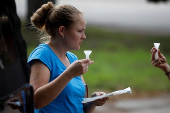 A woman collects a saliva