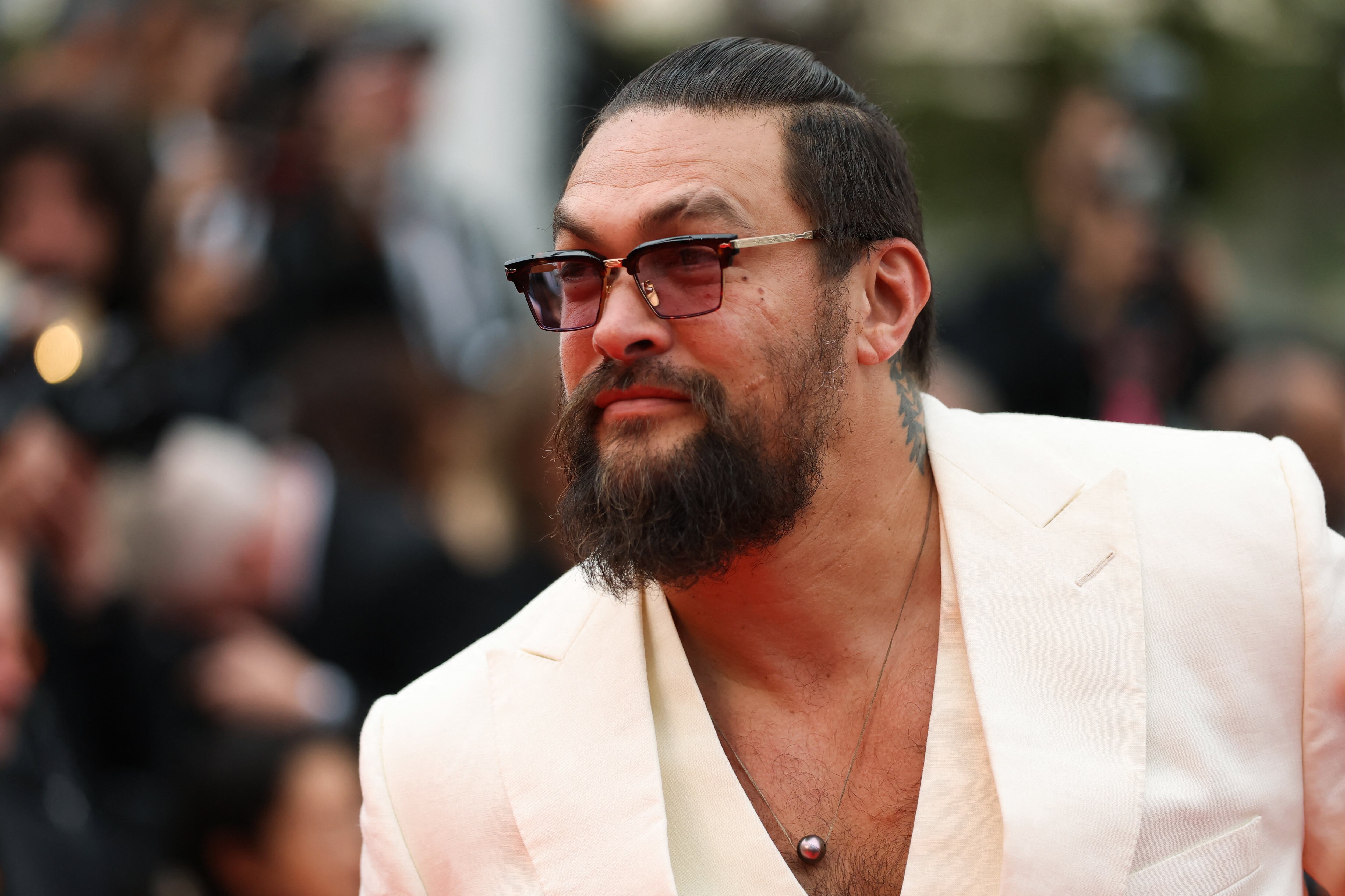 Jason Momoa poses on the red carpet during arrivals for the screening of the film