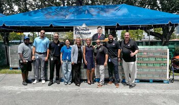 La comisionada de Miami-Dade, Vicki L. López, posa junto a trabajadores de los Marlins y los transportistas de ayuda a Venezuela este lunes en el estacionamiento del estadio loanDepot Park en Miami, Florida (EFE)