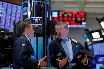 Traders work on the floor