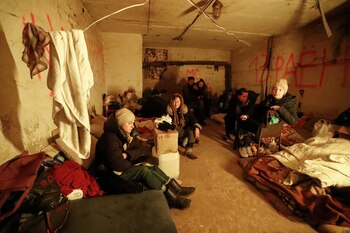 Tamara Bolshakova, 47, her mother Irina, 78, and other local residents stay in the basement of an apartment building in the besieged southern port city of Mariupol, Ukraine March 25, 2022. Tamara Bolshakova lost her son Danil, 22, who died during Ukraine-Russia conflict. REUTERS/Alexander Ermochenko